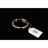 A 9ct gold bamboo effect bangle with safety chain,