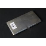 A large silver cigarette case with engine turned decoration (engraved initials),