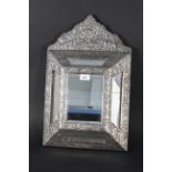 A Middle Eastern white metal fronted wall mirror,