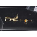 A 14ct gold bowl form brooch together with a yellow metal single stone set brooch,