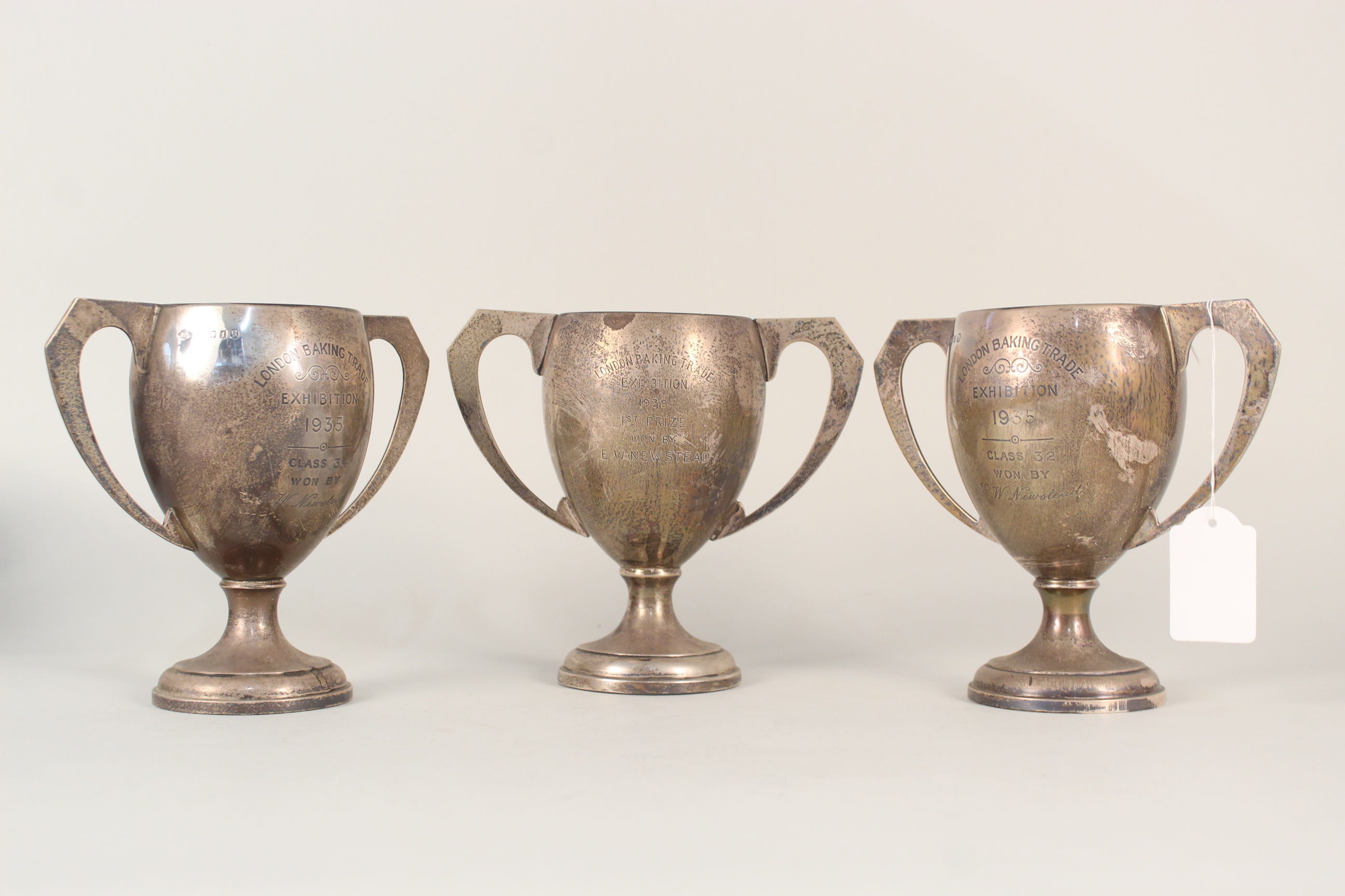 Three silver trophy cups, all with presentation inscriptions,