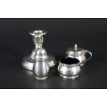 A silver three piece condiment set with Celtic band decoration by Goldsmiths together with a silver