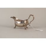 A silver sauce boat with presentation inscription, hallmarked Sheffield,