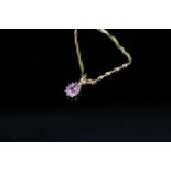An 18ct gold pink sapphire and diamond pendant on 9ct gold chain,
