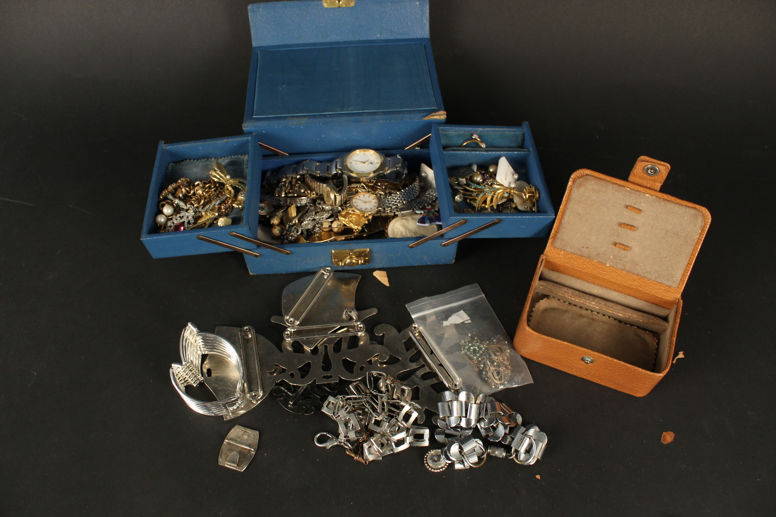 A collection of costume jewellery, a leather jewellery box, large metal necklaces,