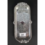 A silver pen tray, Dublin 1819, raised edge border with shell and rib pattern,