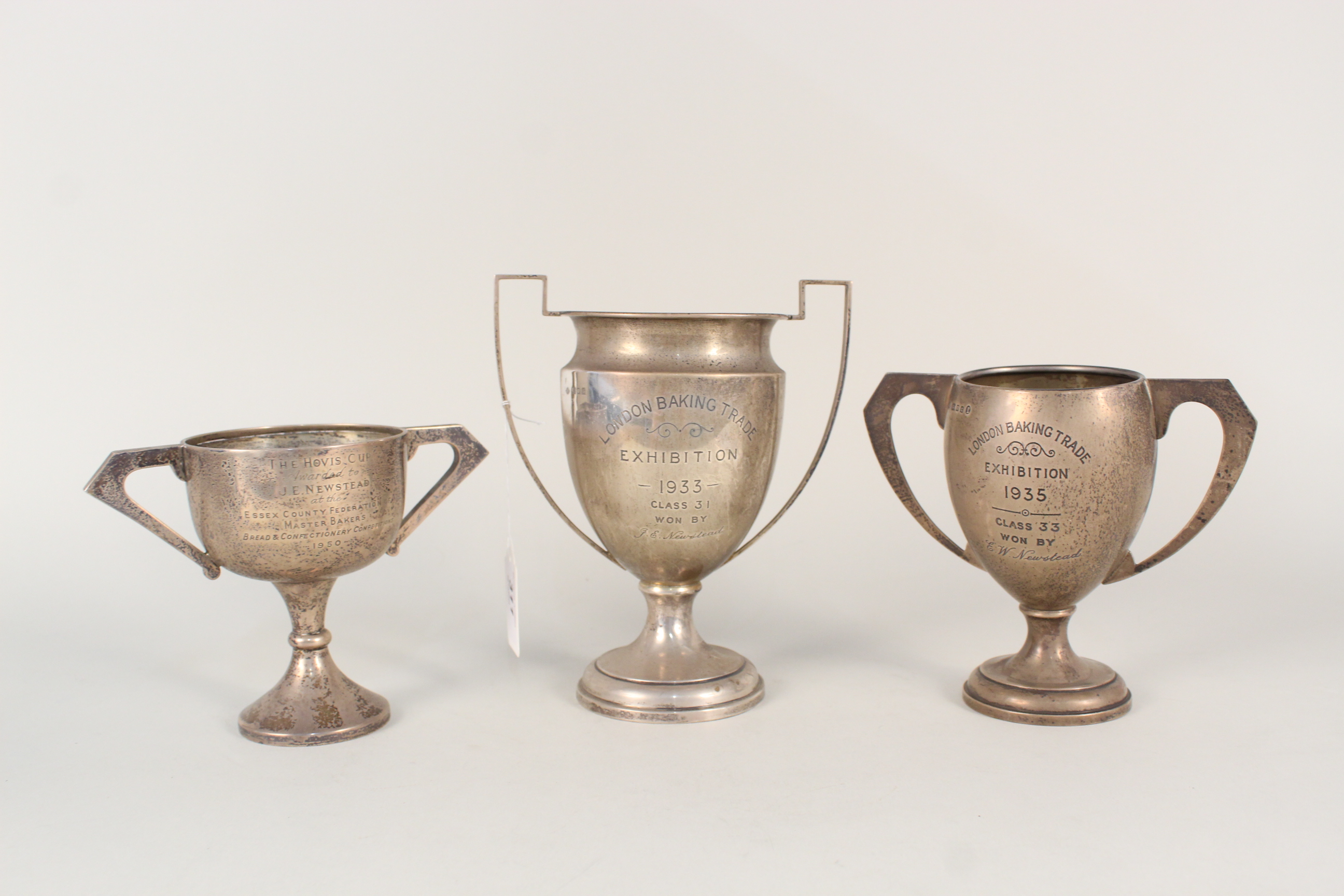 Three silver trophy cups (with presentation inscriptions),