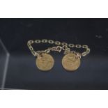 A yellow metal bracelet (one link stamped 375) with two half sovereigns (drilled),