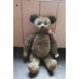 An early 20th Century mohair bear in the Farnell style, hanging long arms, shaved muzzle,
