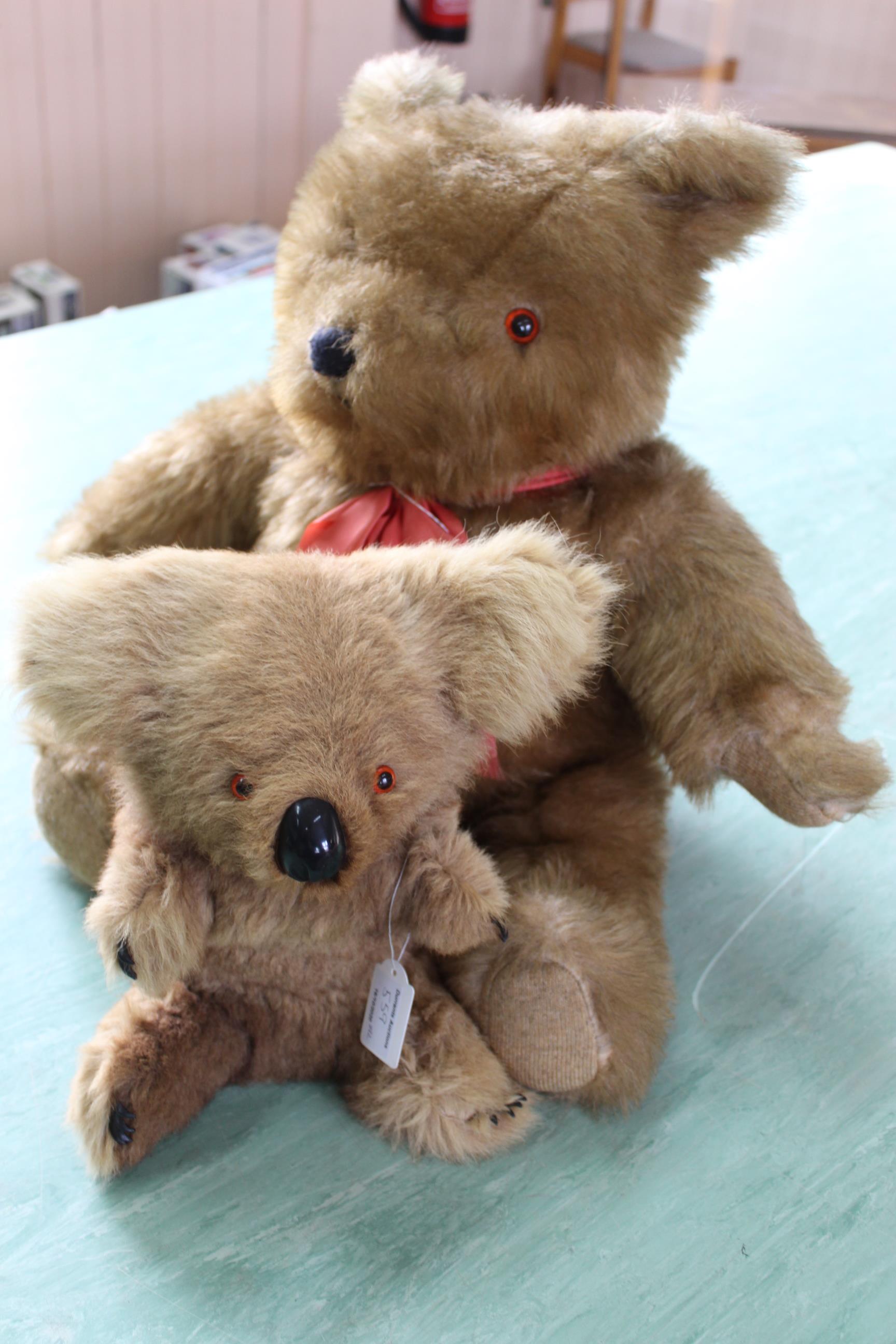 A large sized Teddy bear together with a koala bear