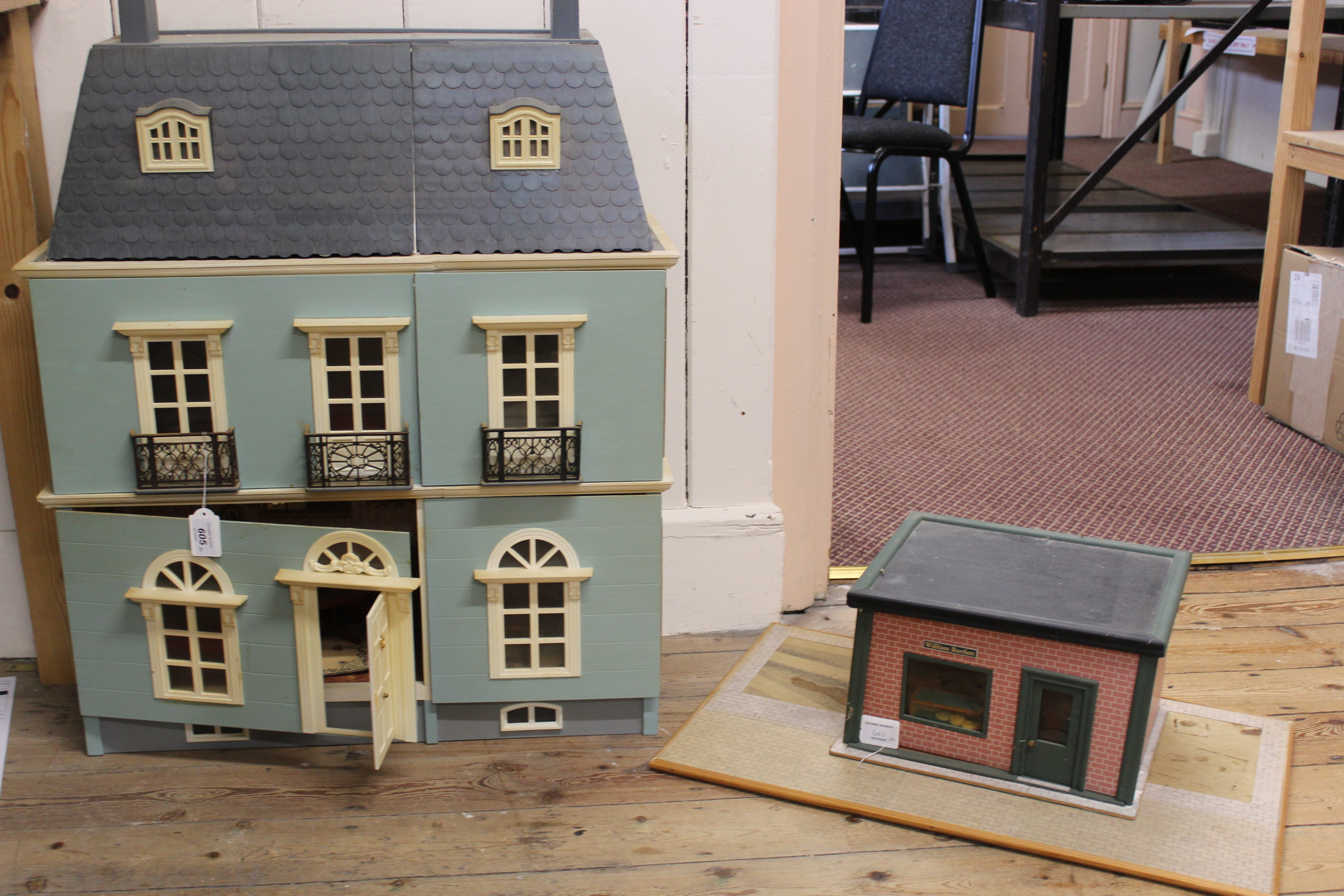 A large vintage dolls house with contents together with a 'William Bartlett' shop and contents