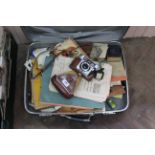 A suitcase containing a large quantity of black and white photos, mainly family,