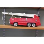 A large sized vintage Tonka tin plate fire engine with extending plastic ladder (playworn