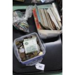 A tray with a tub of British and foreign coinage including two £1 pound notes,