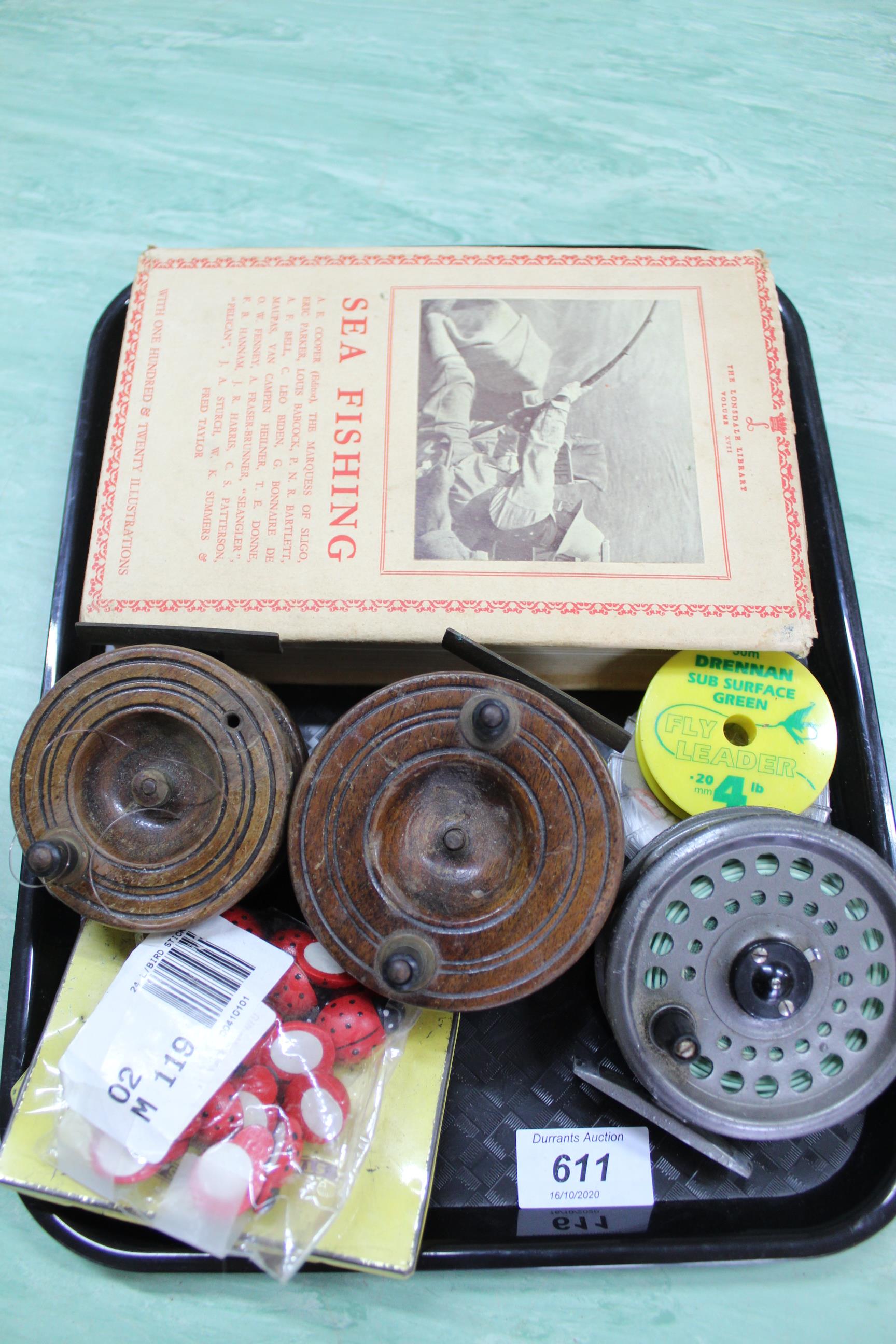 A collection of vintage fishing reels plus a bound copy of Sea Fishing by A E Cooper