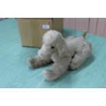 A 20th Century soft toy poodle with movable legs