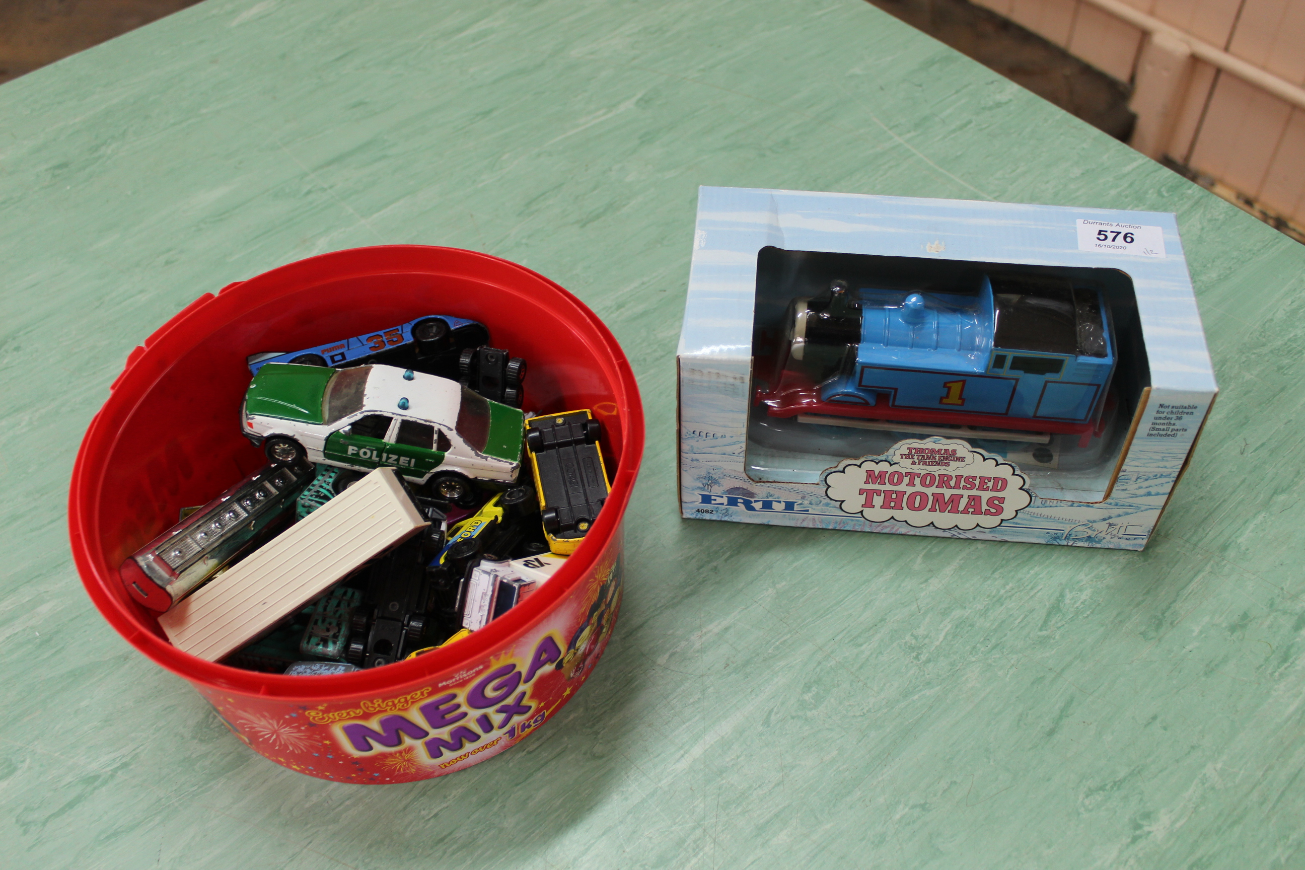 A boxed motorised Thomas the Tank Engine together with a tub of vintage Matchbox and Corgi cars