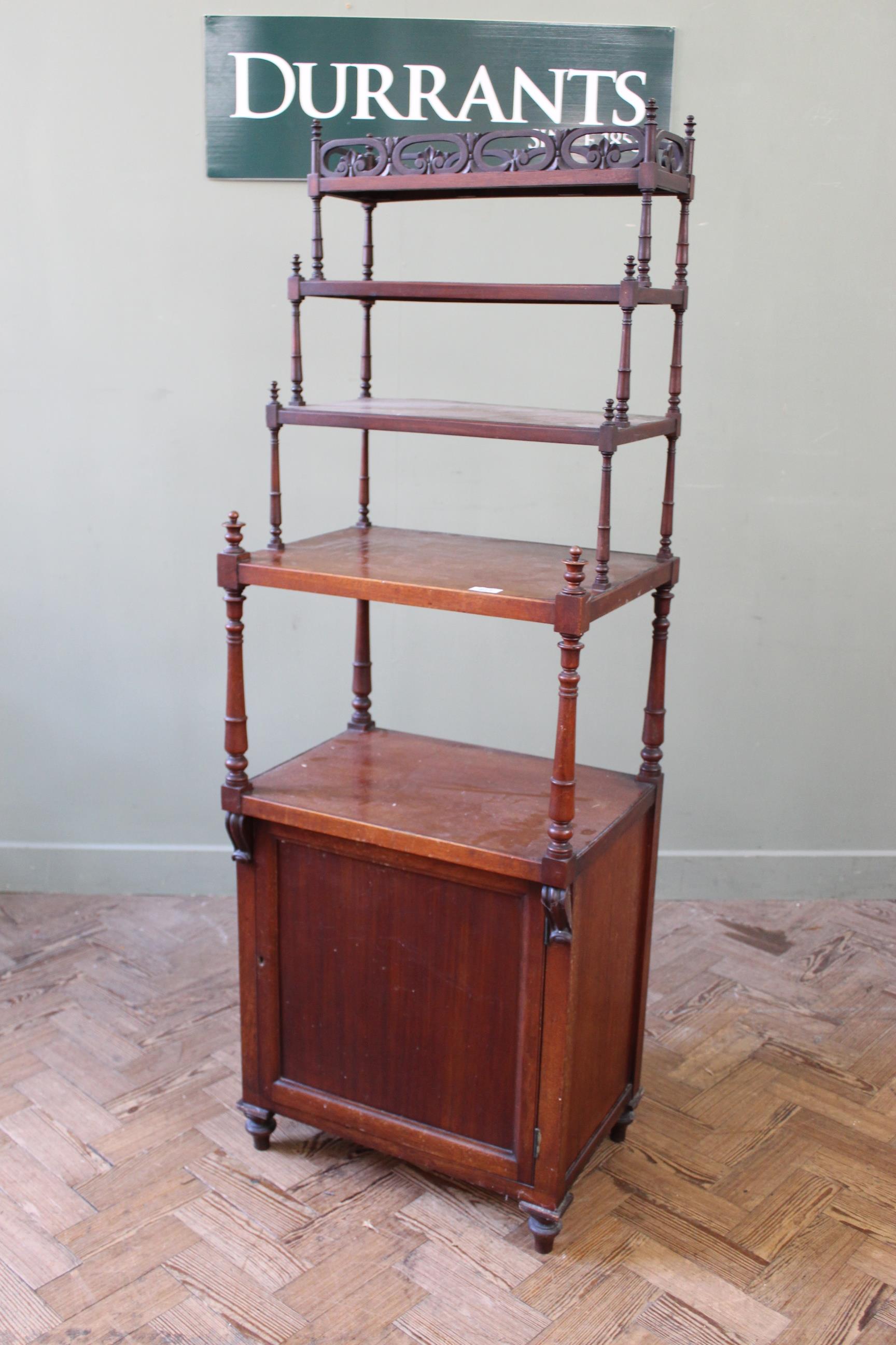 A 19th Century mahogany four tier whatnot with cupboard base