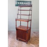 A 19th Century mahogany four tier whatnot with cupboard base