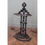 A Victorian Gothic revival cast iron stick stand with lift out tray,