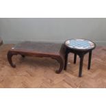 A Chinese carved hardwood coffee table on convex end supports and an ebonised round coffee table
