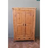 A late 19th Century pine continental cut double wardrobe