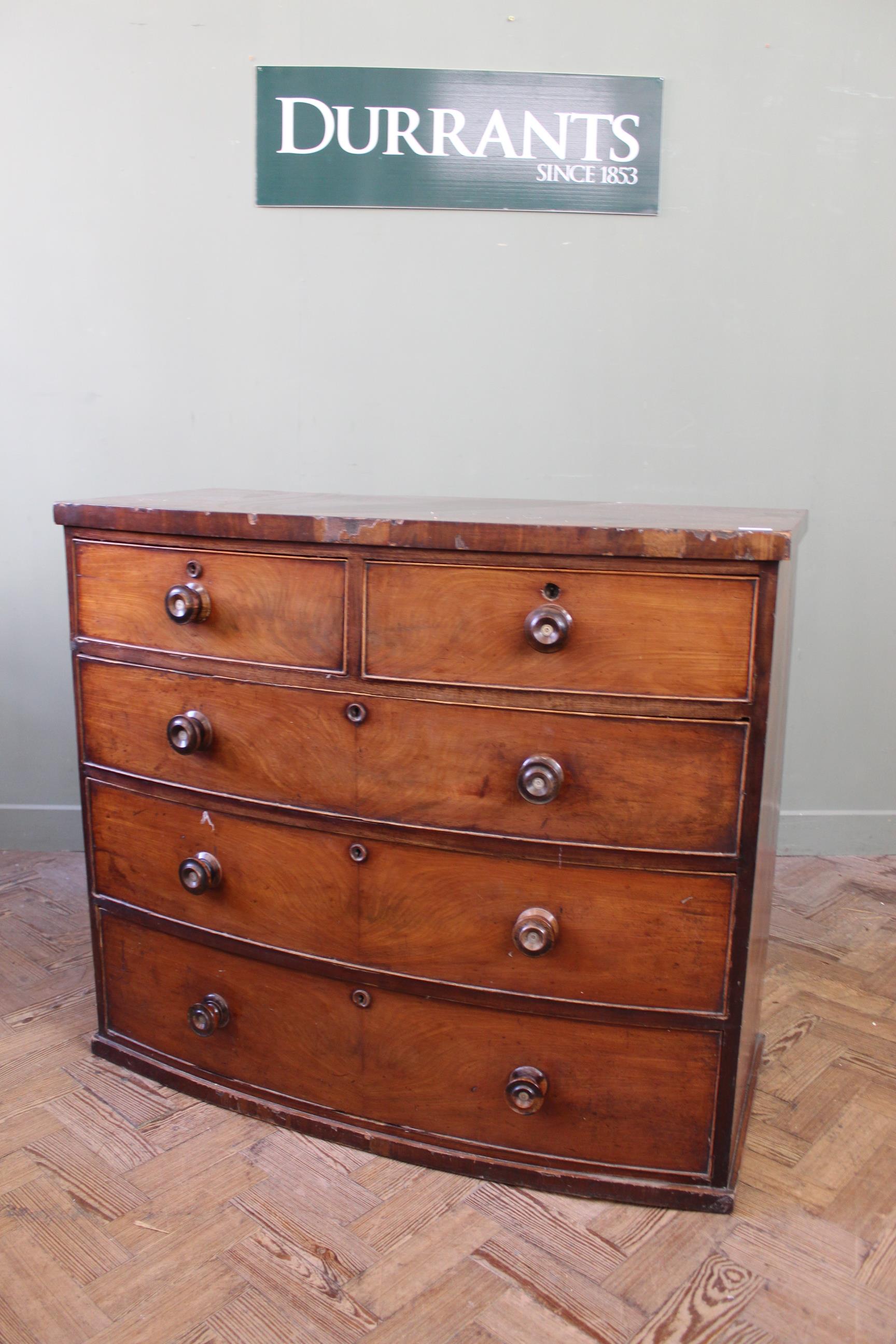 An early Victorian bow fronted chest of two short and three long drawers,
