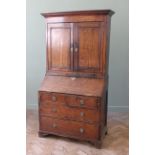 An early 19th Century country oak bureau bookcase with fitted interior,