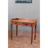 A Victorian mahogany writing table with two drawers and galleried upstand