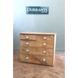 A mid Victorian pine chest of five drawers and porcelain knobs (missing feet)