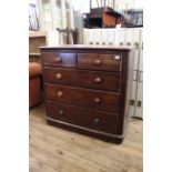 A late Victorian mahogany five drawer chest on bun feet