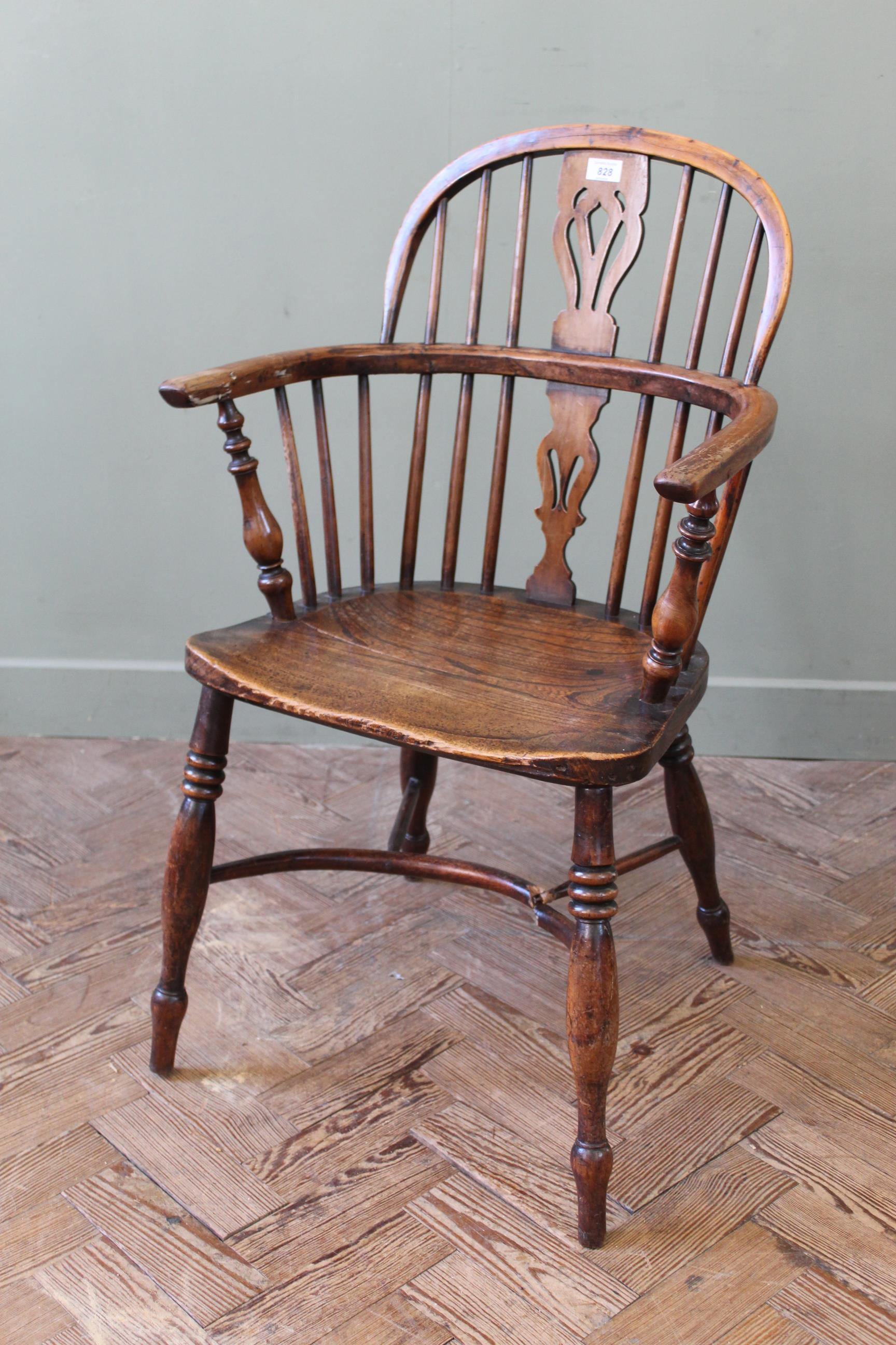 An early 19th century yew and elm Windsor chair stamped 'F.