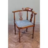 An Edwardian inlaid mahogany corner stretcher chair