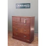 An Edwardian chest of five drawers with original brass handles