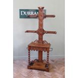 A Victorian oak bobbin turned hall stand with four branches and a drawer