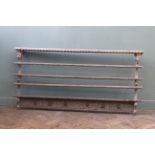 An early 19th Century carved plate rack,