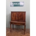 An early 19th Century mahogany cabinet on later stand with fitted interior