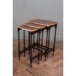 An Edwardian mahogany nest of three tables with gilt mouldings