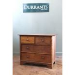 An Edwardian oak four drawer chest (replaced knobs)