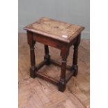 An early 19th Century oak stretcher stool