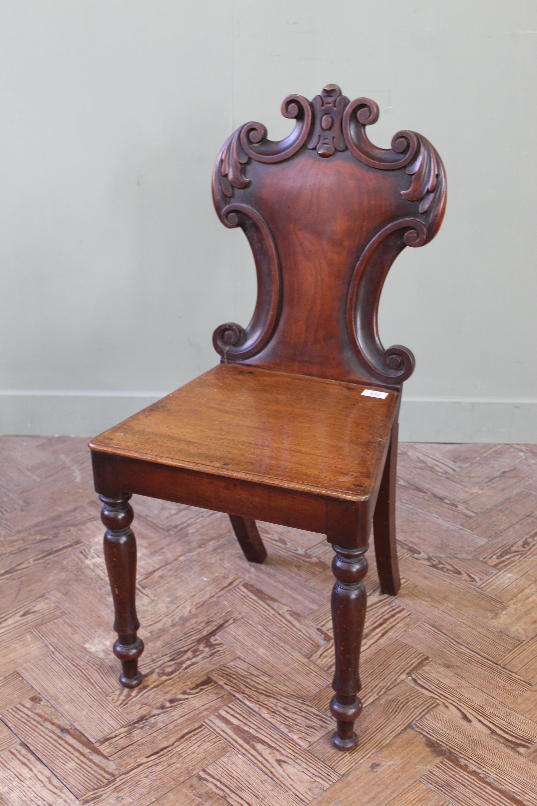 A Regency carved mahogany hall chair