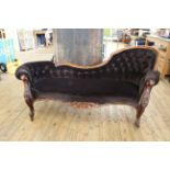 A mid Victorian carved mahogany button back chaise longue