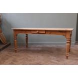 A Victorian style stripped pine dining table