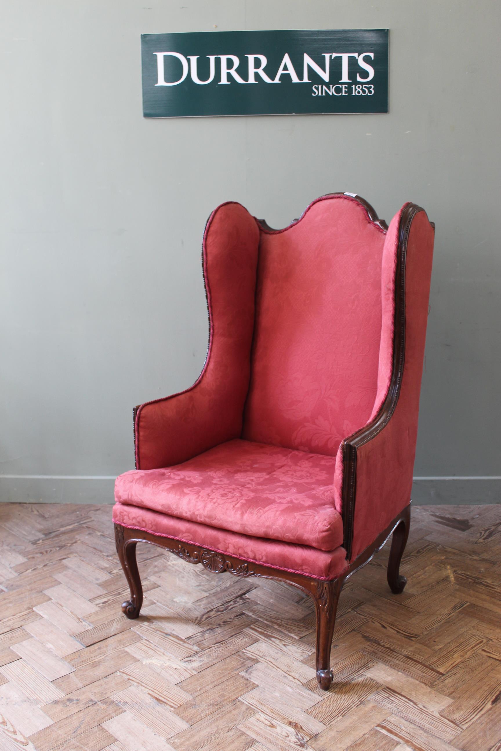 An early 20th Century mahogany Victorian style wing back chair