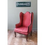 An early 20th Century mahogany Victorian style wing back chair