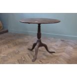 An early 19th Century mahogany tripod table with flip lid