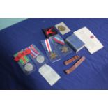 Four WWII medals, cloth title,