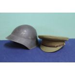 An Officers peaked cap with a Swiss M18 helmet