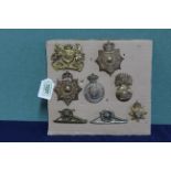 A group of eight British military badges and 'plates'