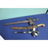 Two Kris knives, one with ornately carved hilt and scabbard,